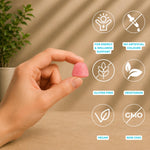 A hand holds a small pink gummy against a warm beige background with soft leaf shadows. White circular icons with bright blue text highlight product benefits: for energy & wellness support; no artificial colours; gluten free; vegetarian; vegan; and non-GMO